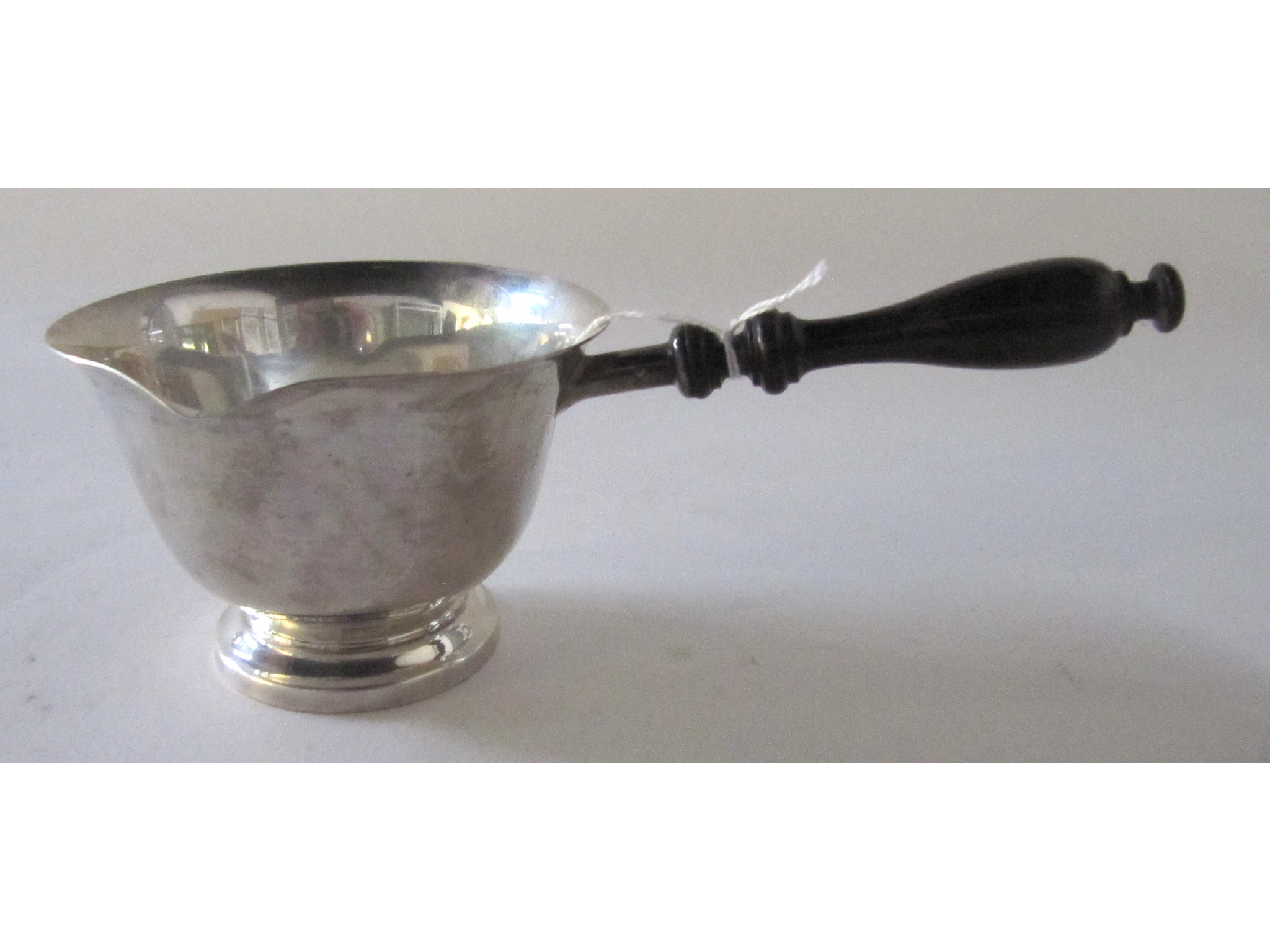 Appraisal: A sterling silver brandy warmer with turned wood handle