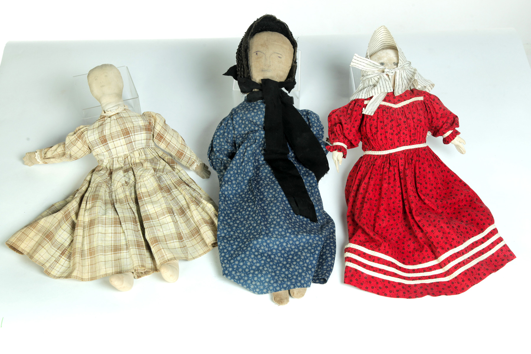 Appraisal: THREE AMERICAN DOLLS Late th-early th century Stuffed cloth dolls