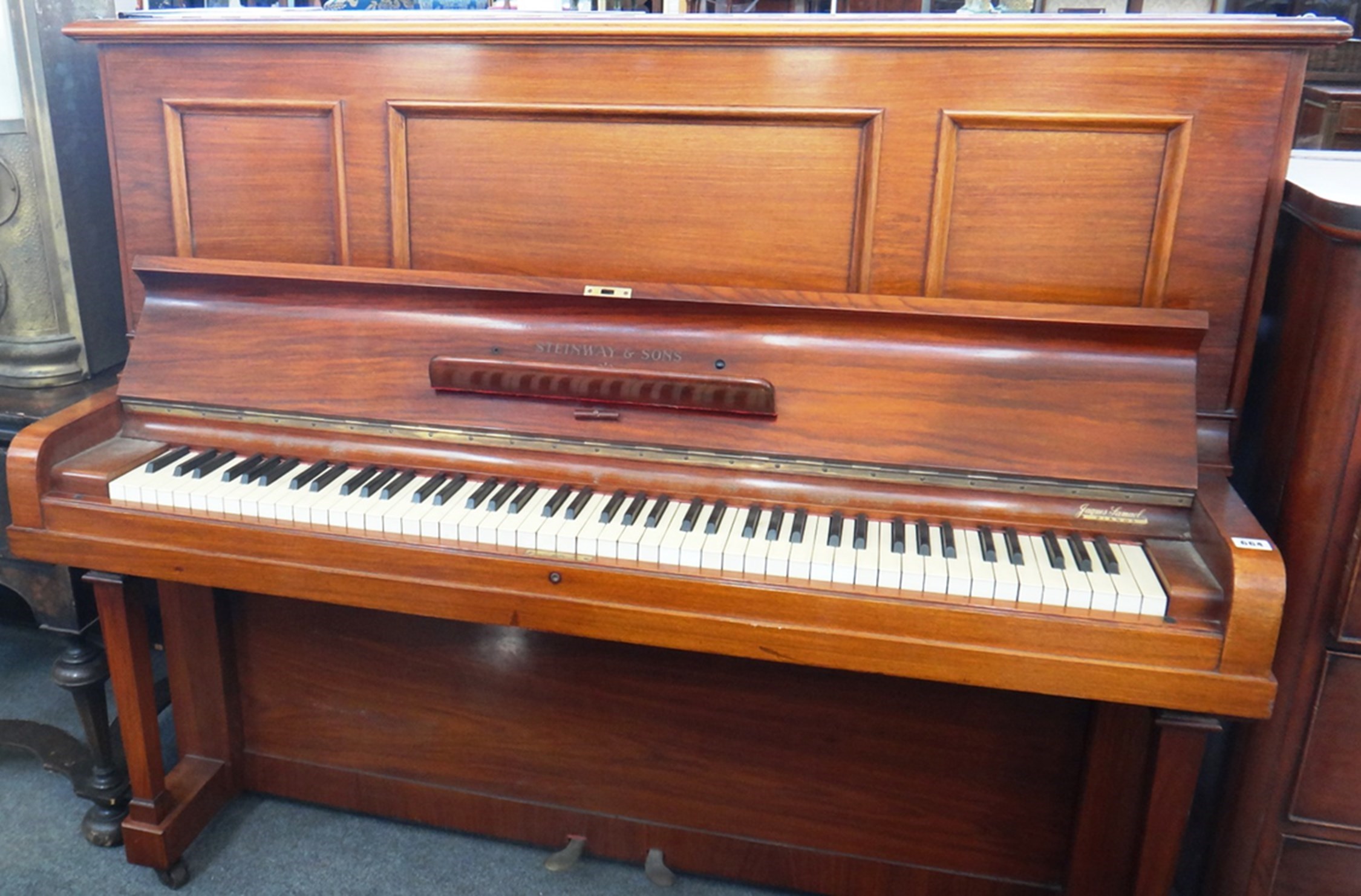 Appraisal: A rosewood cased upright iron framed overstrung piano by Steinway