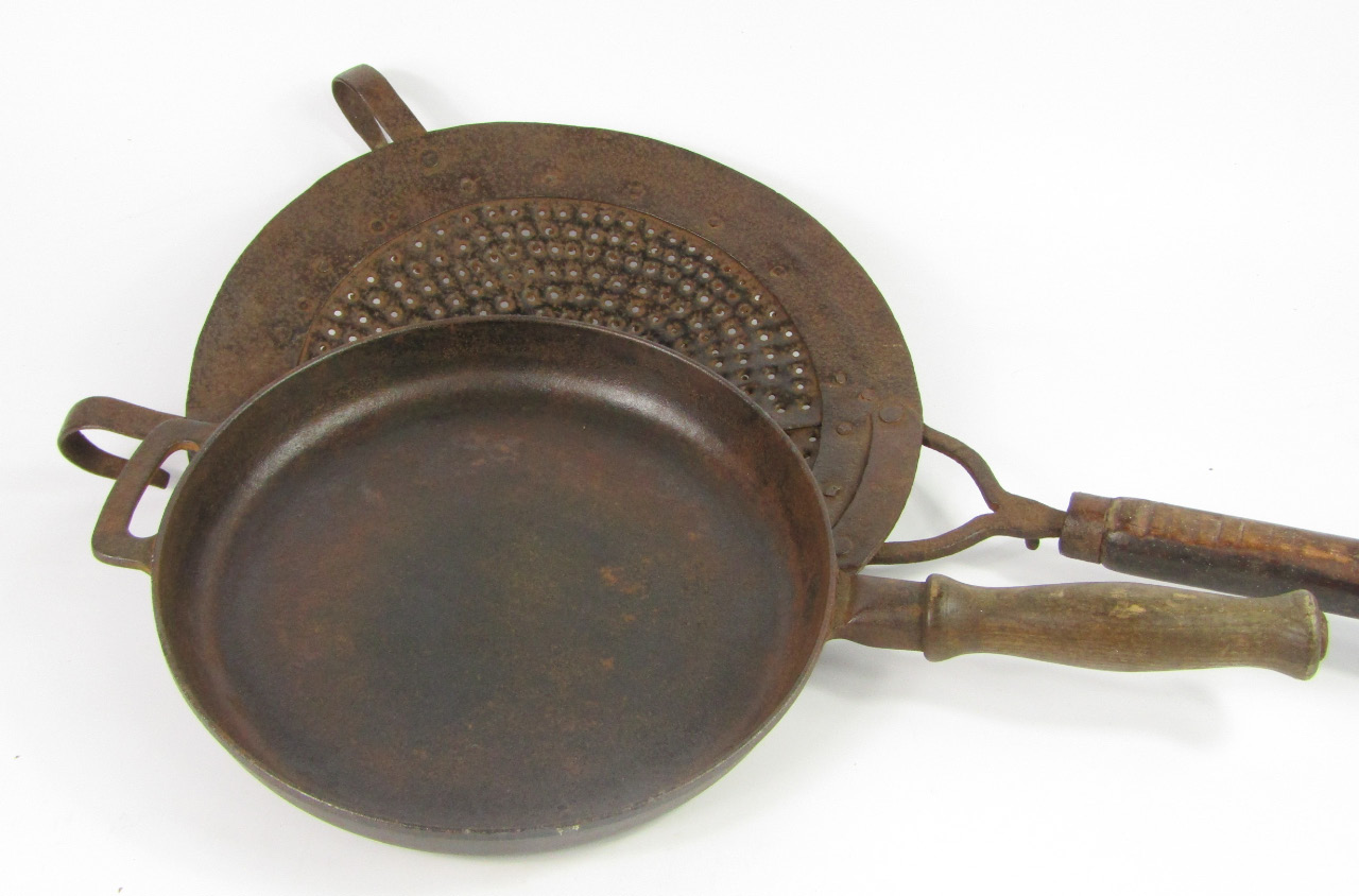 Appraisal: A cast iron chestnut roaster with a wooden handle cm