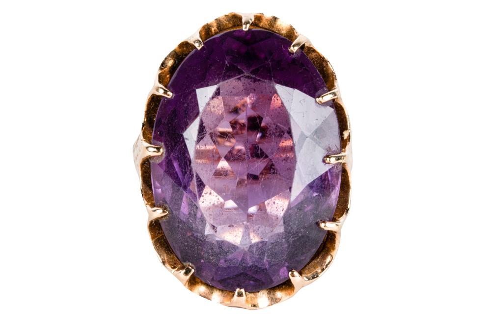 Appraisal: KARAT YELLOW GOLD AMETHYST RINGcentering one oval cut natural amethyst