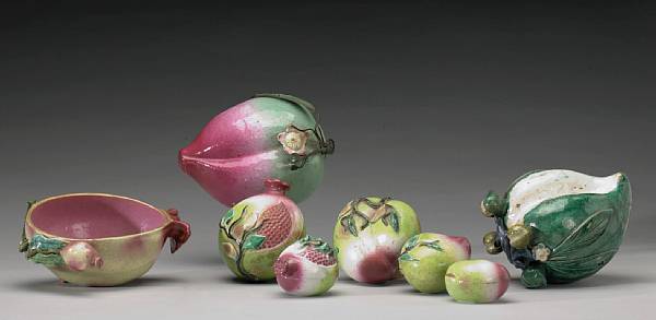 Appraisal: A group of polychrome enameled pottery fruit Including three large