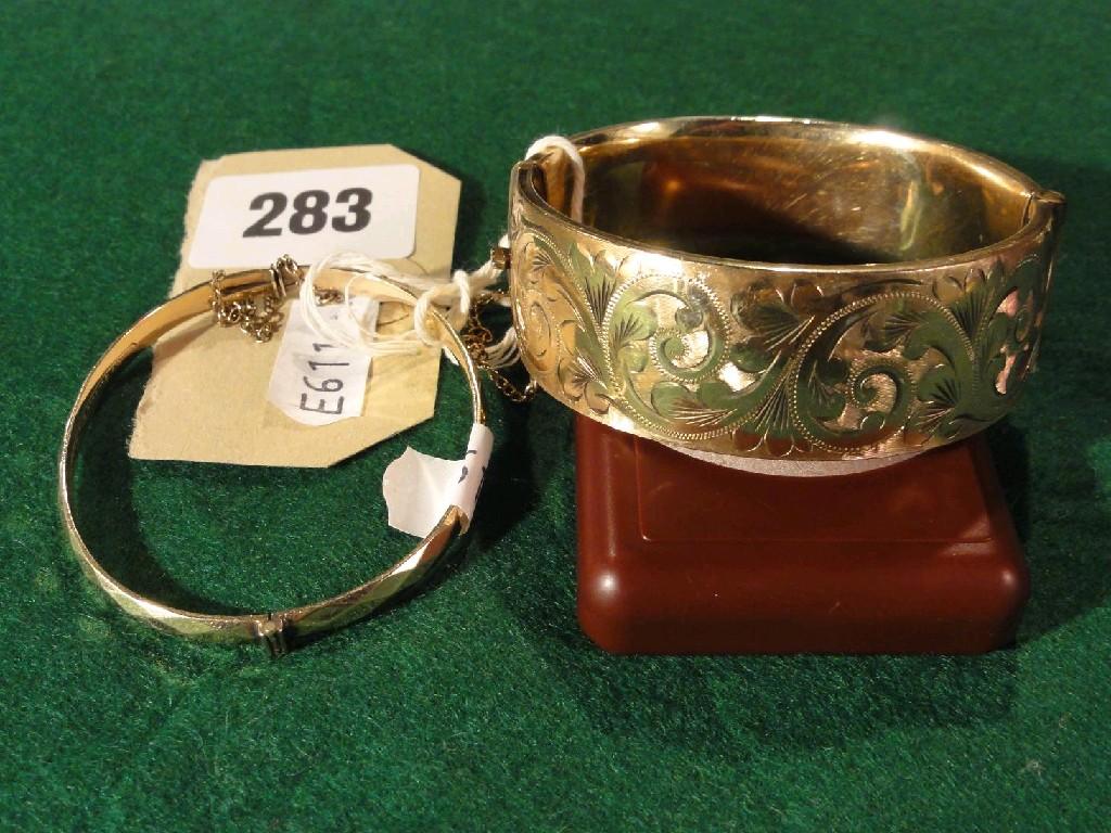 Appraisal: A gilt bracelet with engraved decoration together with a smaller