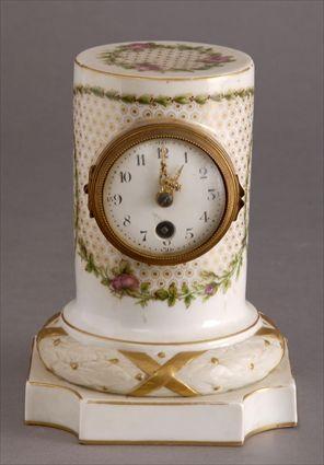 Appraisal: NEOCLASSICAL-STYLE PORCELAIN PILLAR CLOCK The in enamel dial with gilt-metal