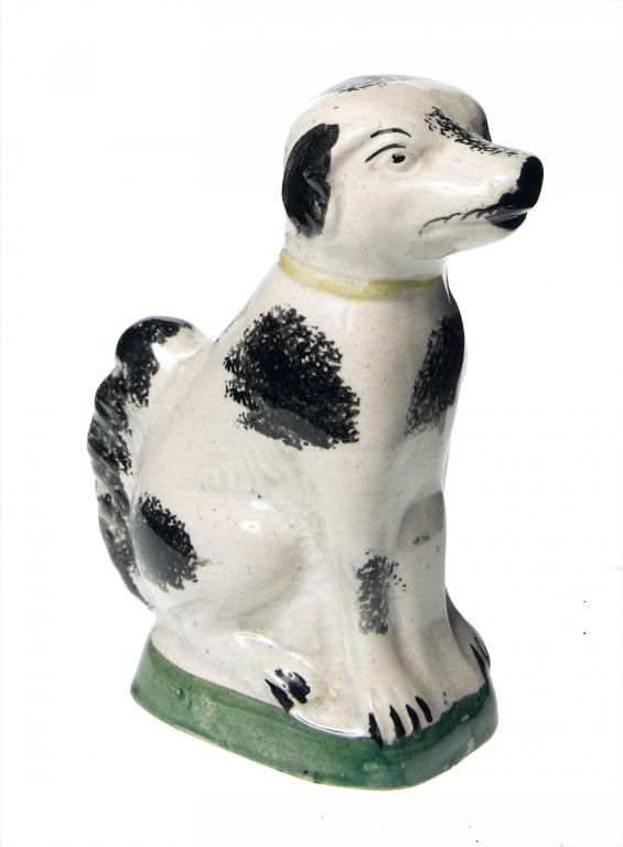 Appraisal: A SPONGEWARE DOG of crudely moulded slip cast earthenware sponged