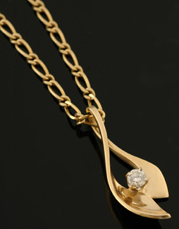 Appraisal: A diamond pendant and chain The abstract open form pendant