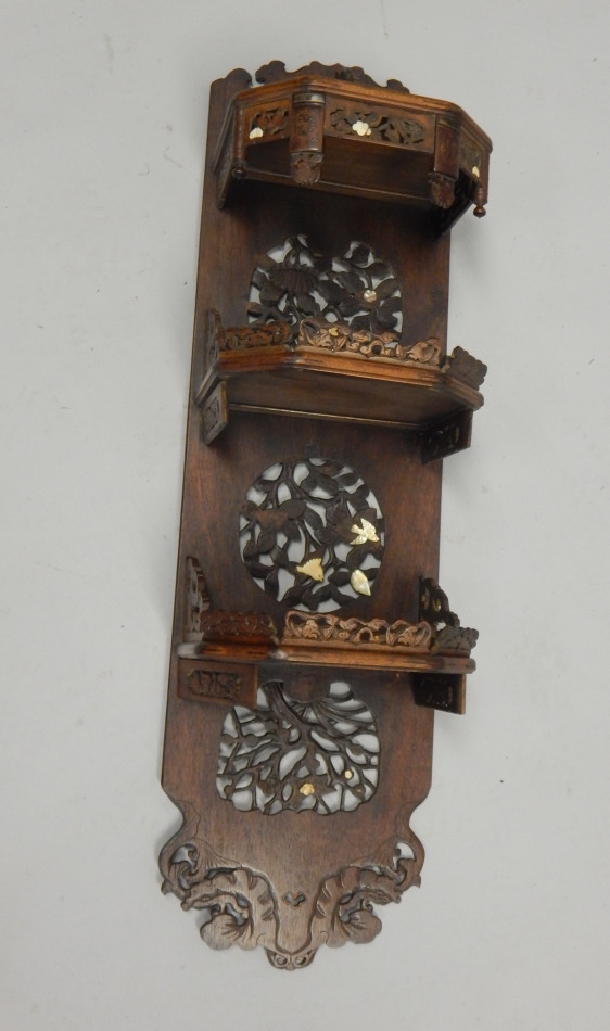 Appraisal: A Japanese hardwood three tier wall shelf with applied decoration