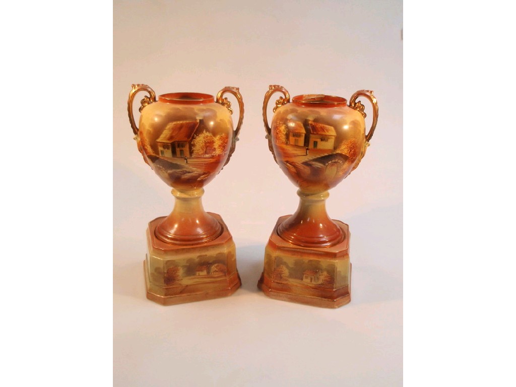 Appraisal: A pair of Staffordshire topographical painted vases on stands cm