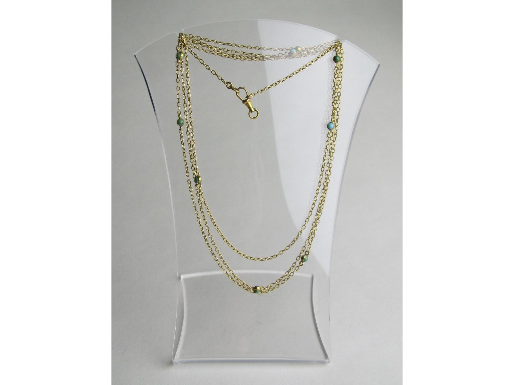 Appraisal: Nine carat gold guard chain with turquoise spacers Approximately inches