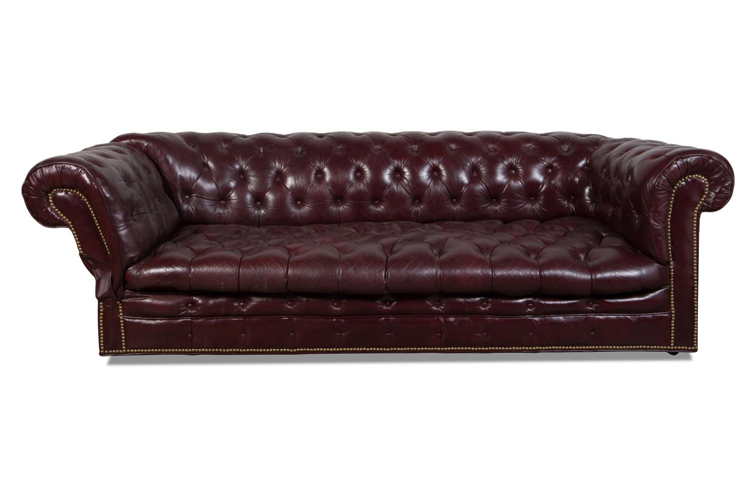 Appraisal: BURGUNDY LEATHER RECLINING CHESTERFIELD SOFA Burgundy leather Chesterfield sofa having