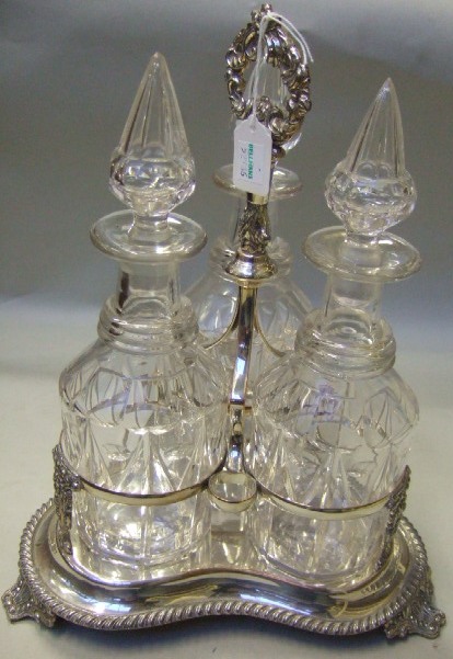 Appraisal: A Sheffield plated triple section decanter stand decorated with a