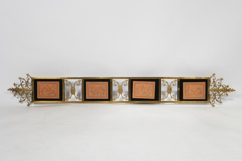 Appraisal: A GILT METAL AND TERRACOTTA MOUNTED WALL PANEL the horizontal