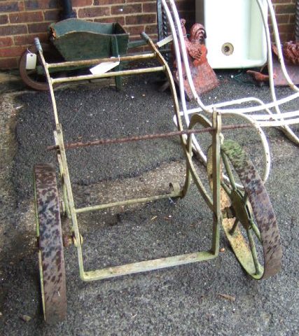 Appraisal: The wrought iron frame and wheels for a water bowser