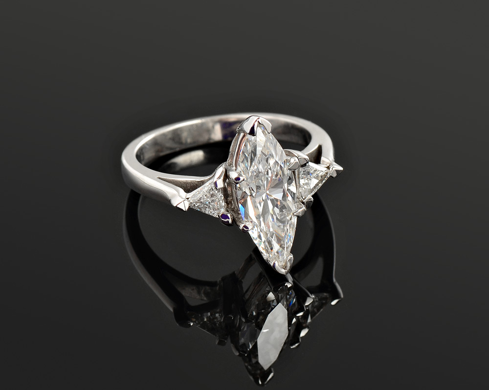 Appraisal: CT MARQUISE DIAMOND SOLITAIRE WITH TRIANGLE CUT SIDE DIAMONDS In