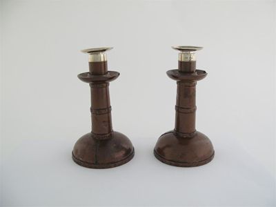 Appraisal: A pair of unusual late Victorian arts crafts candlesticks mounted