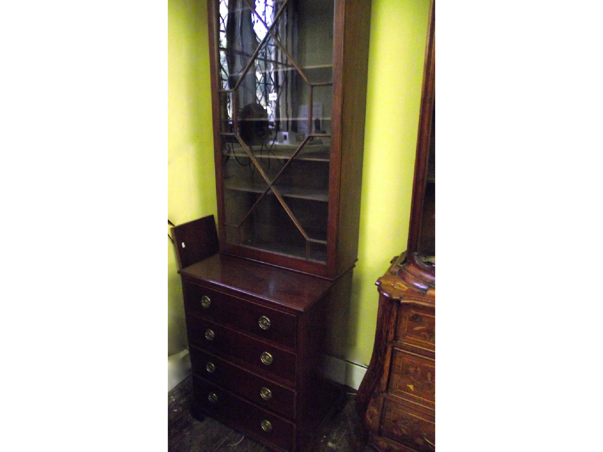 Appraisal: A Georgian style freestanding cabinet the lower section enclosed by