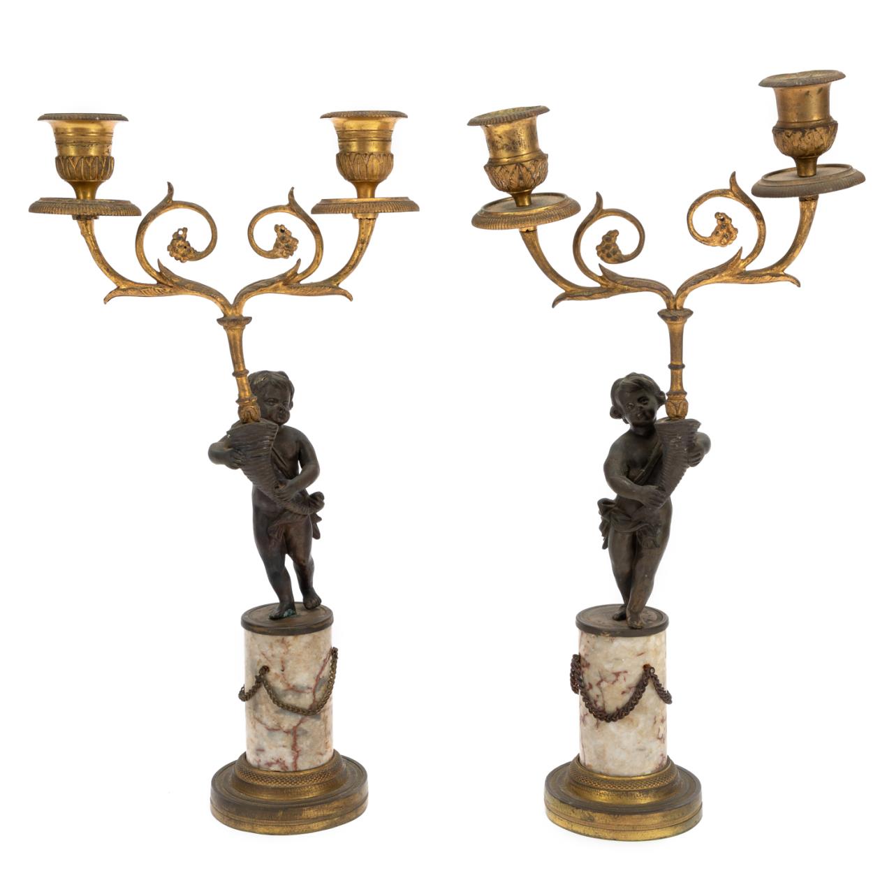 Appraisal: PAIR LOUIS XVI STYLE TWO LIGHT PUTTI CANDELABRA Pair of