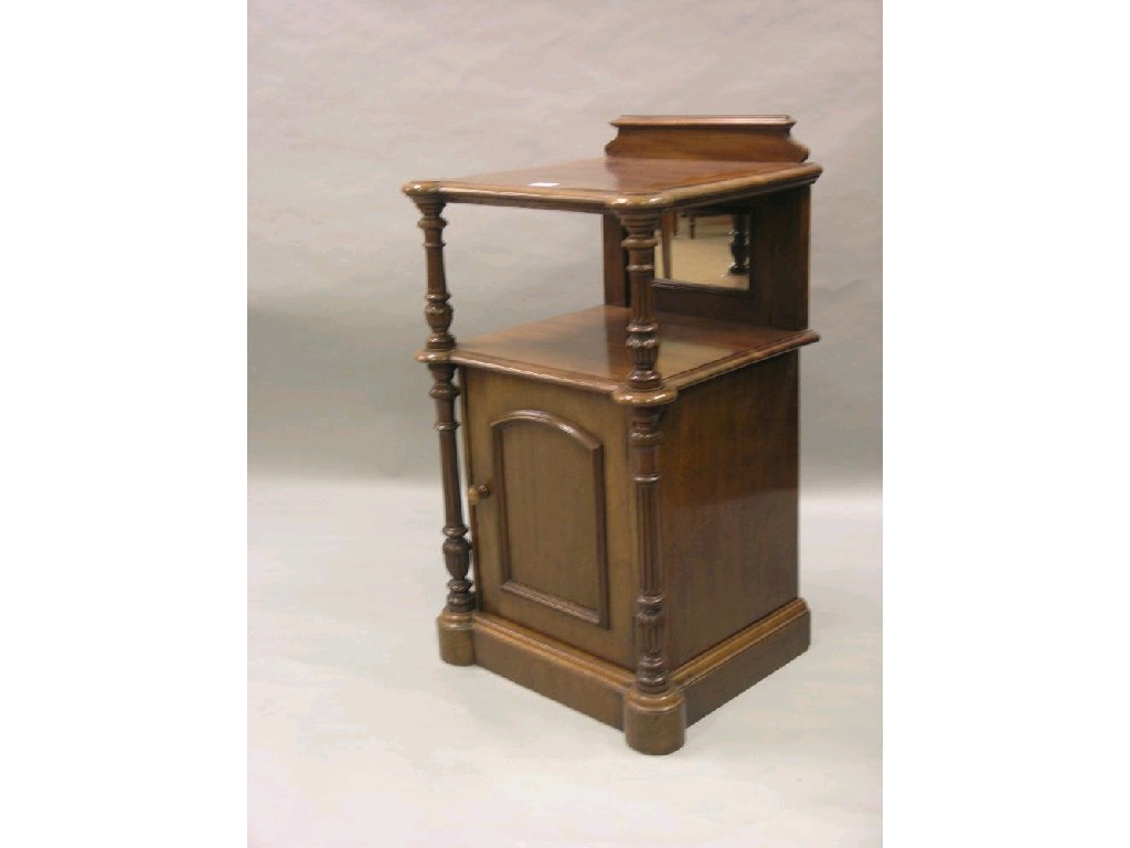 Appraisal: A Victorian mahogany bedside table two-tiered with panelled cupboard base