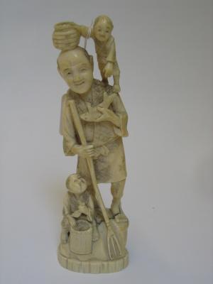 Appraisal: AN IVORY OKIMONO c carved as a fisherman holding a