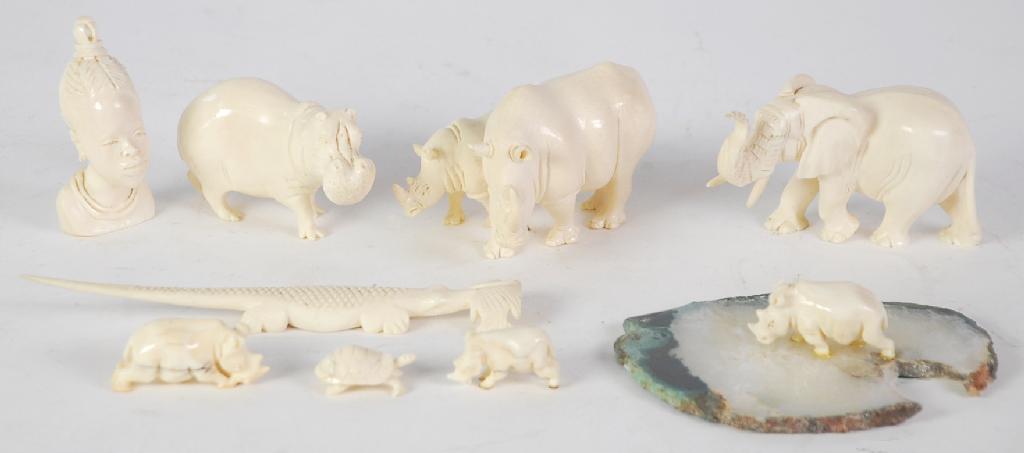 Appraisal: THREE CARVED MARINE IVORY MODELS OF ANIMALS comprising Rhinoceros with