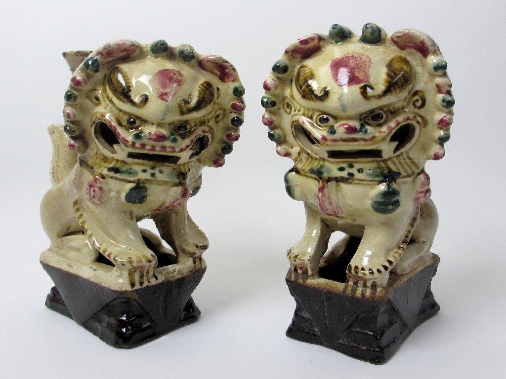 Appraisal: A pair of Chinese pottery dogs of fo incense holders