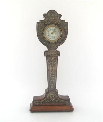 Appraisal: A modern mounted wooden timepiece with a bevelled oblong base