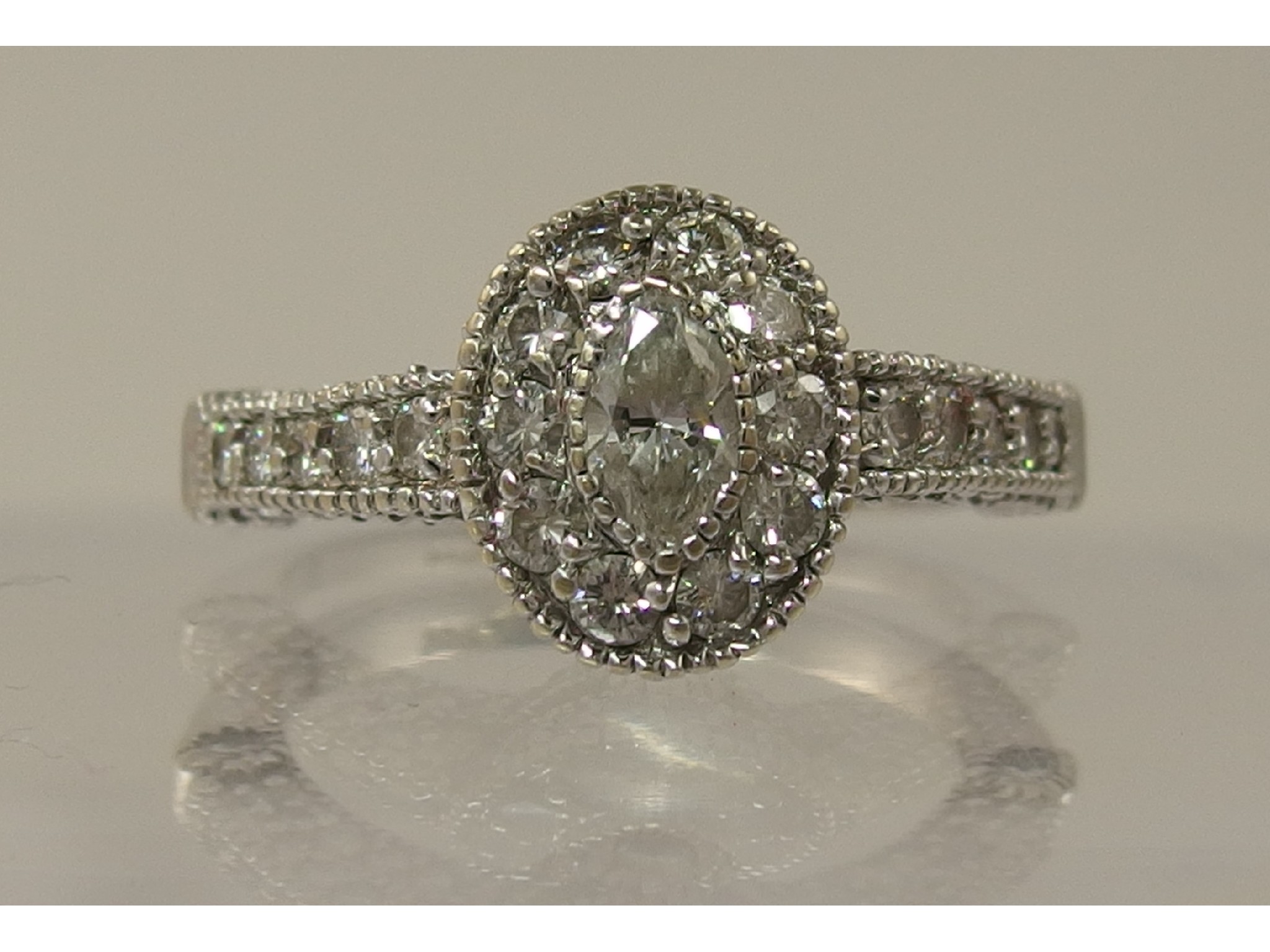 Appraisal: A diamond cluster ring of approximately cts combinedthe central marquis