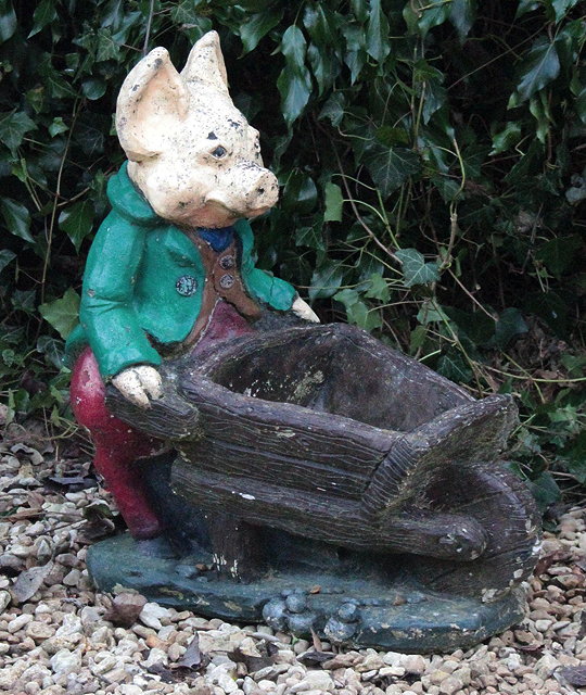 Appraisal: A PAINTED CAST CONCRETE PIG with a wheelbarrow cm high