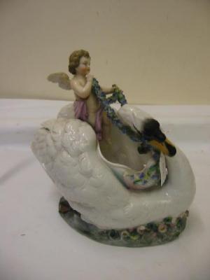 Appraisal: A CONTINENTAL PORCELAIN FIGURAL JARDINIERE modelled as a cherub riding