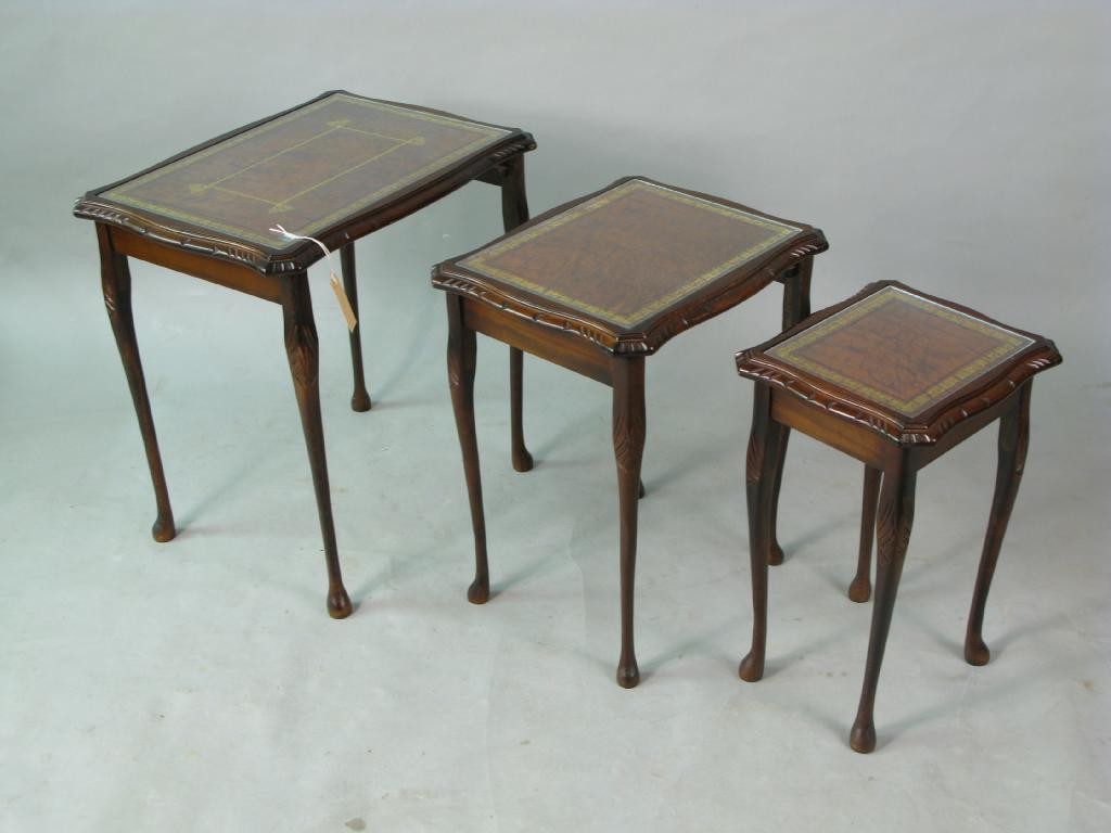 Appraisal: A mahogany nest of three tables each with inset gilt-tooled