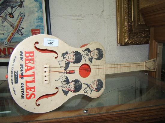 Appraisal: A CHILD'S PLASTIC BEATLES GUITAR the fab four on the