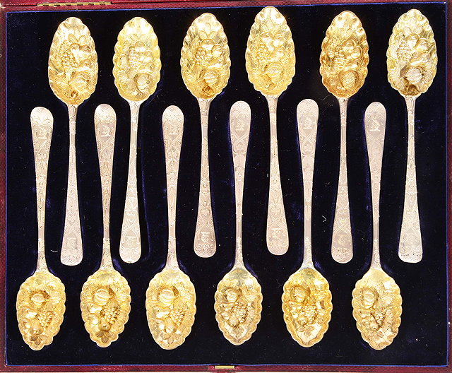 Appraisal: A SET OF TWELVE SILVER BERRY SPOONS with embossed gilt