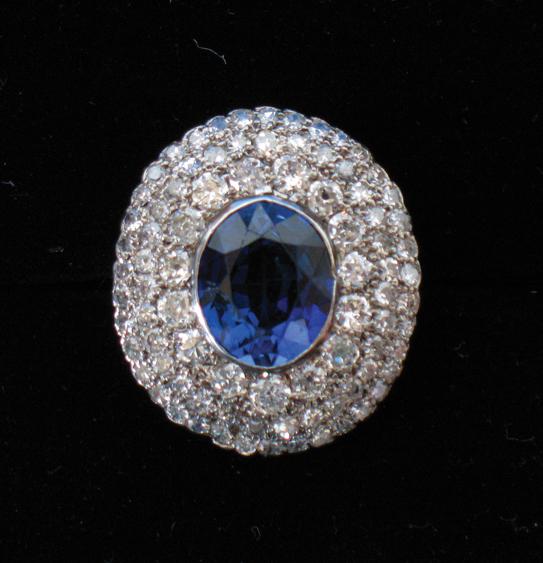 Appraisal: A DIAMOND AND SAPPHIRE CLUSTER RING the central oval cushion-cut