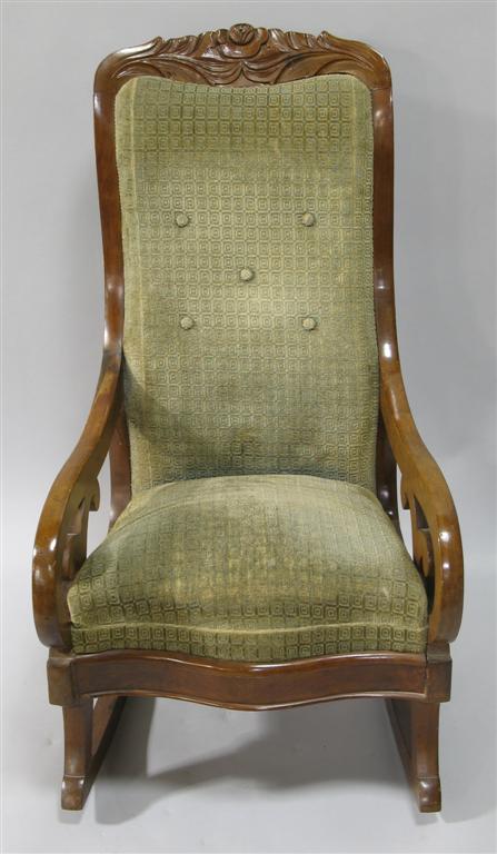 Appraisal: VICTORIAN VELVET UPHOLSTERED ROCKING CHAIR The crestrail carved as a