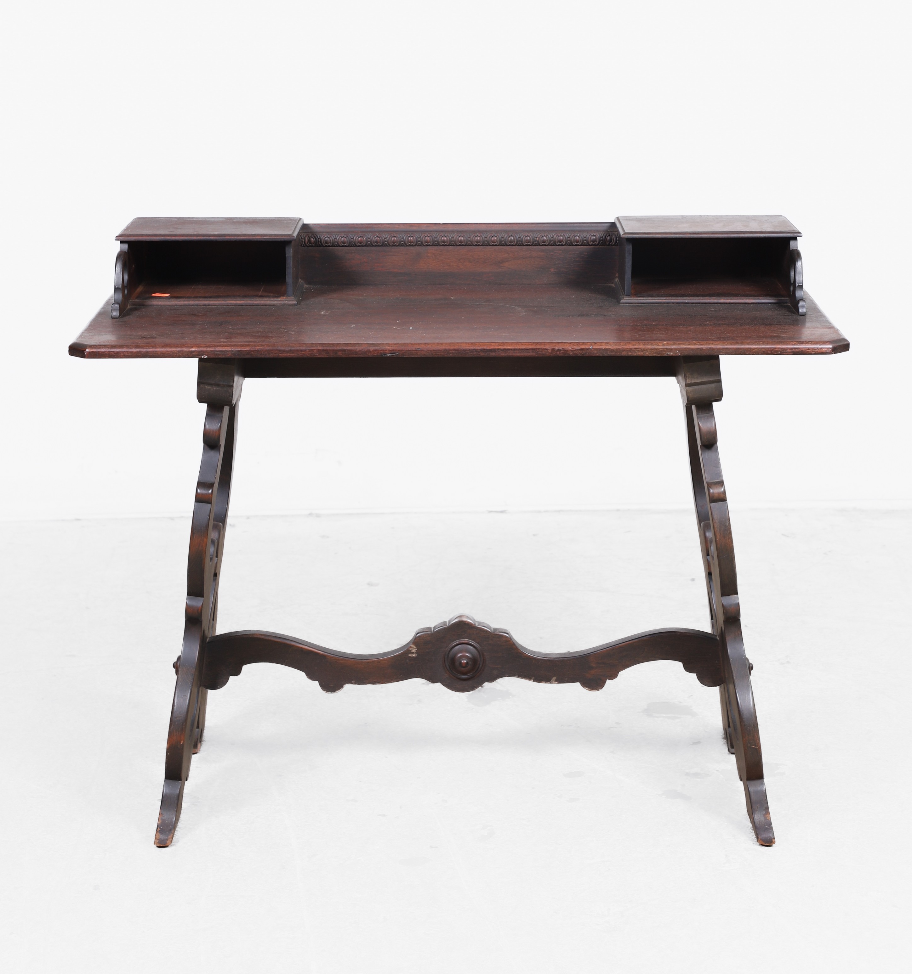 Appraisal: Victorian mahogany carved library table pierced carved and scrolled stretcher