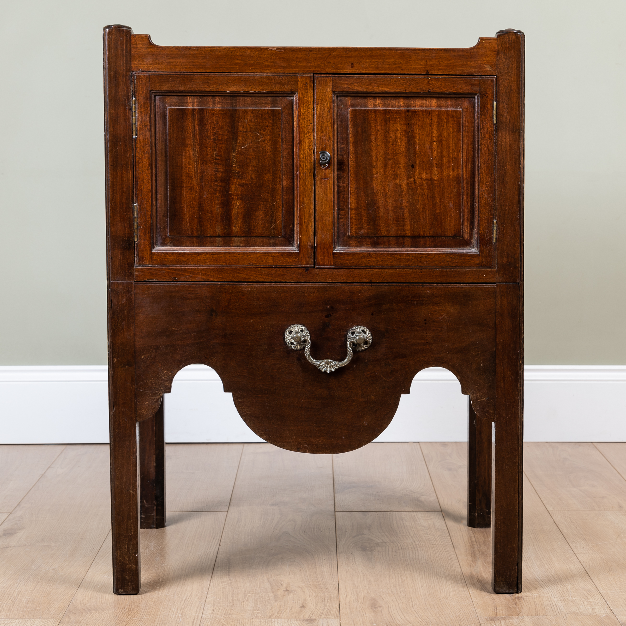 Appraisal: A George III mahogany pot cupboard with galleried top over