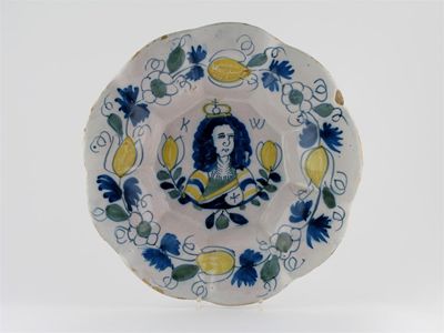 Appraisal: A lobed Delft dish the well painted with a portrait