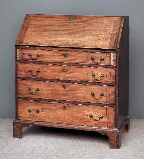 Appraisal: A George III mahogany bureau the slope enclosing seven small