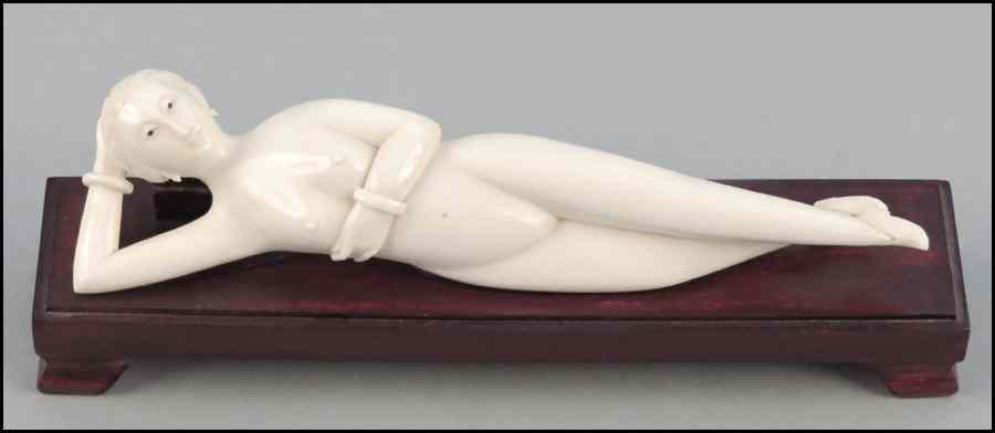 Appraisal: CARVED IVORY FIGURE OF A RECLINING NUDE Raised on a