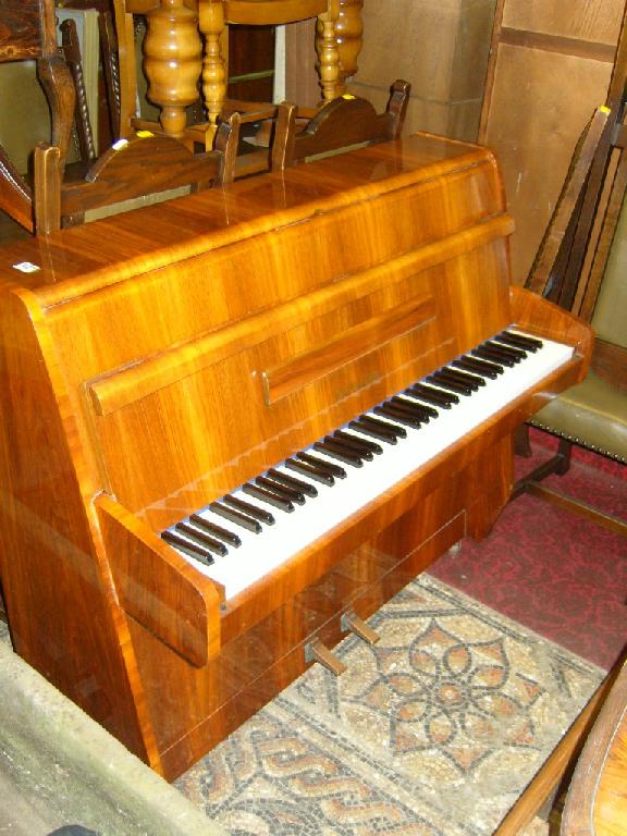 Appraisal: A modern upright iron framed and over strung six octave