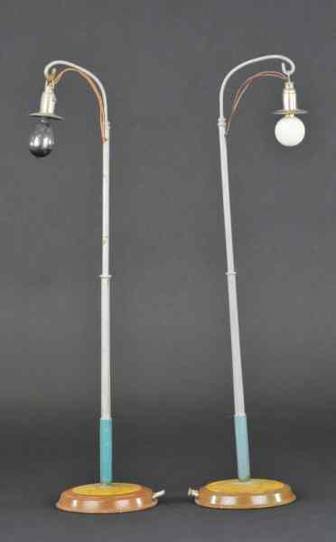 Appraisal: MARKLIN TALL STREET LAMPS Germany matching pair poles painted in