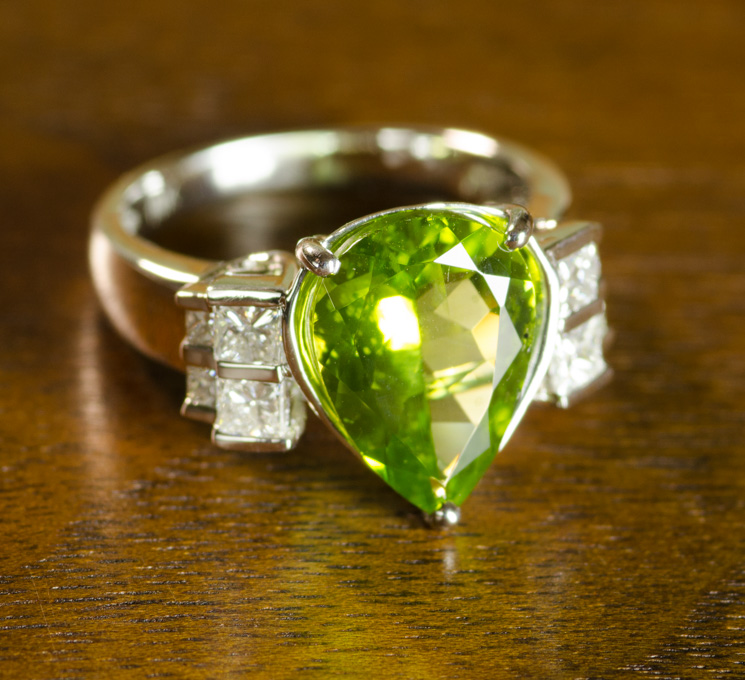 Appraisal: PERIDOT DIAMOND AND FOURTEEN KARAT WHITE GOLD RING with four