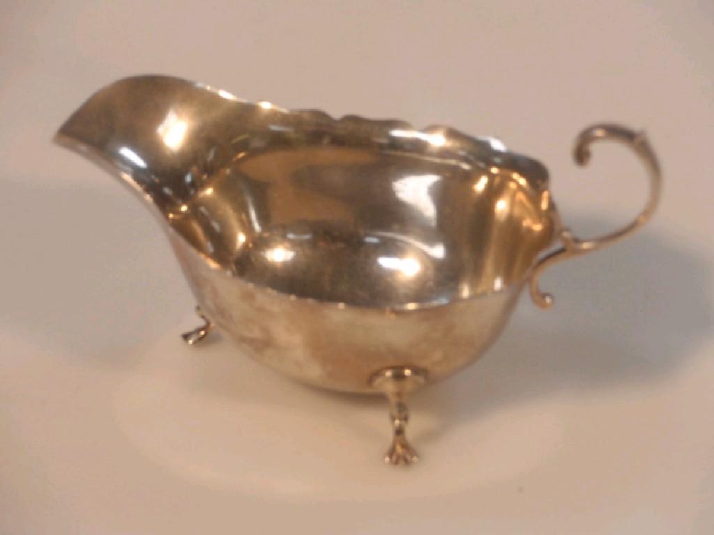 Appraisal: A George V silver sauce boat by Walker Hall Birmingham