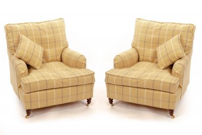 Appraisal: A pair of Howard style deep-seated armchairs fitted loose cushions