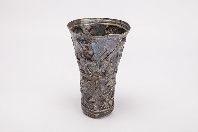 Appraisal: A PERSIAN SILVER TAPERING BEAKER decorated an animal story perhaps