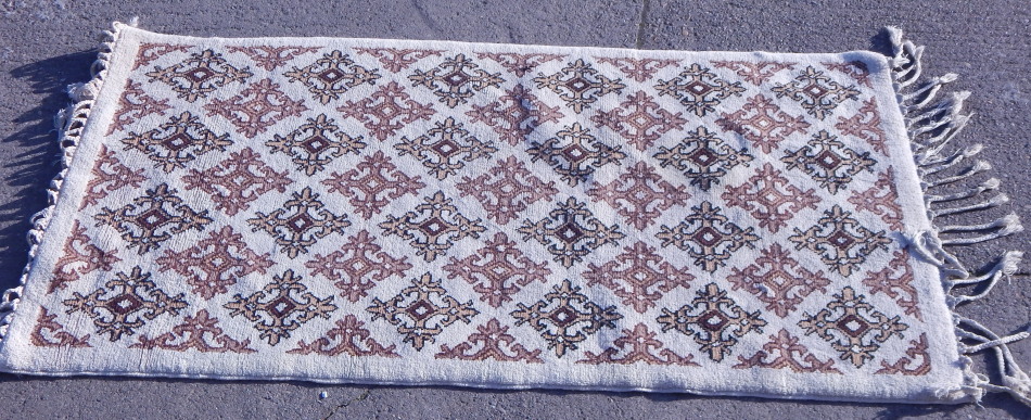 Appraisal: A Persian design Afghan rug with medallions on a cream