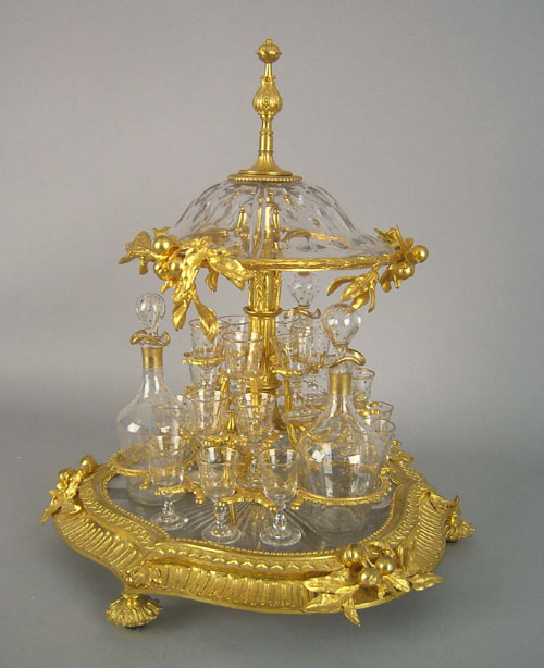 Appraisal: French gilt bronze and glass cased cordial set with decanters