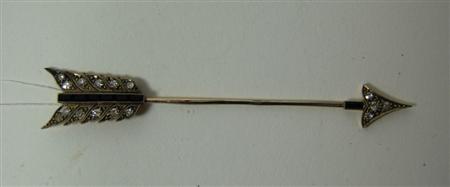 Appraisal: An onyx and diamond set surete pin designed as an