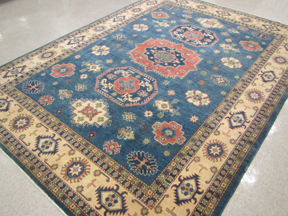 Appraisal: HAND KNOTTED ORIENTAL CARPET Pakistani Caucasian three geometric medallions and