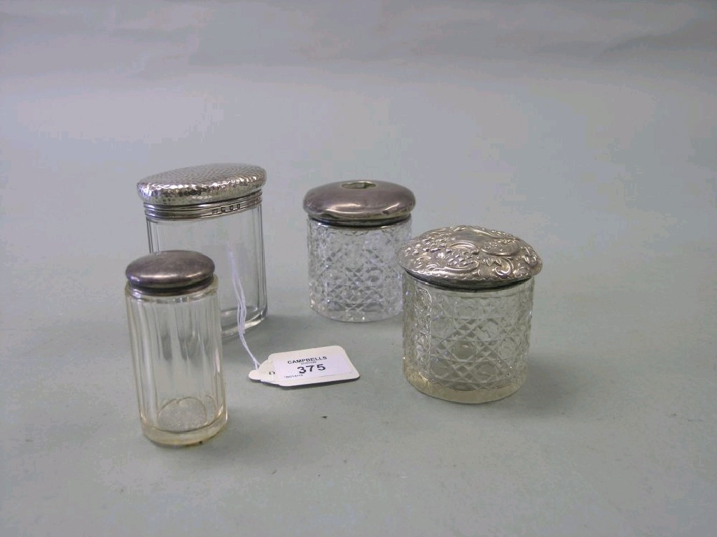 Appraisal: Four various silver mounted glass dressing bottles tallest in